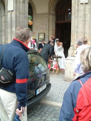A just married couple is sawing a log in half right outside the city hall where they had been married!