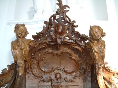 Crying grouchy cherubs on the confessional