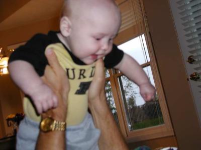 getting a playful lift from dad