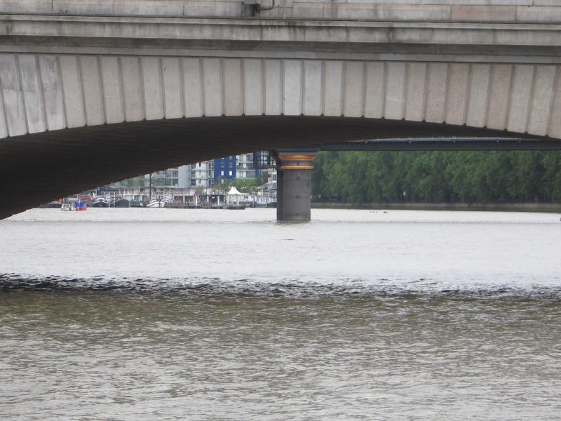 Pier of Fulham railway bridge, looking under Putney bridge.