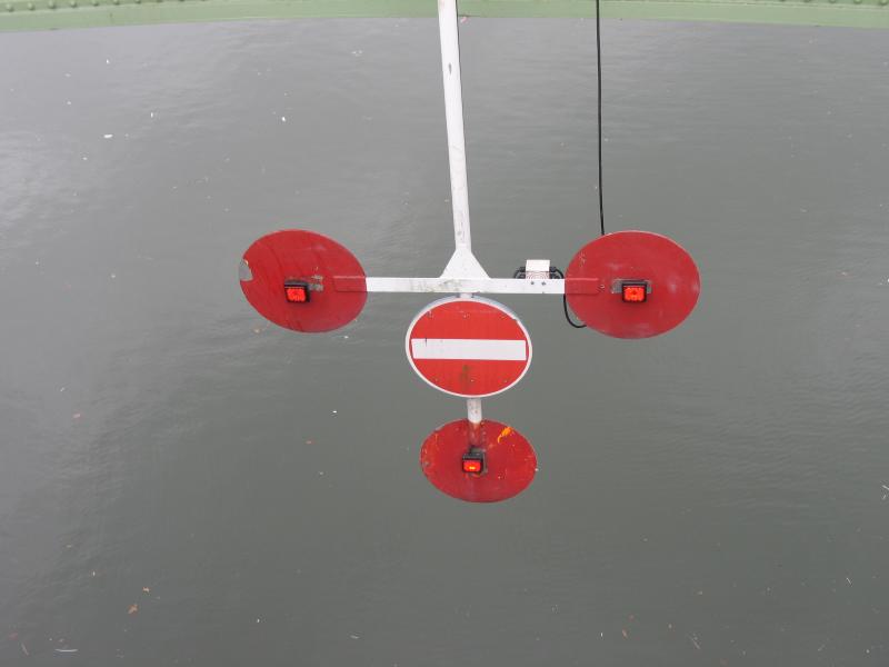 Stop sign for boats under bridge.