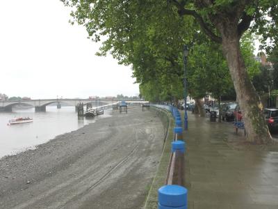 Embankment looking towards bridge at low tide.