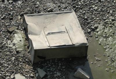 Large metal bin thrown in river.