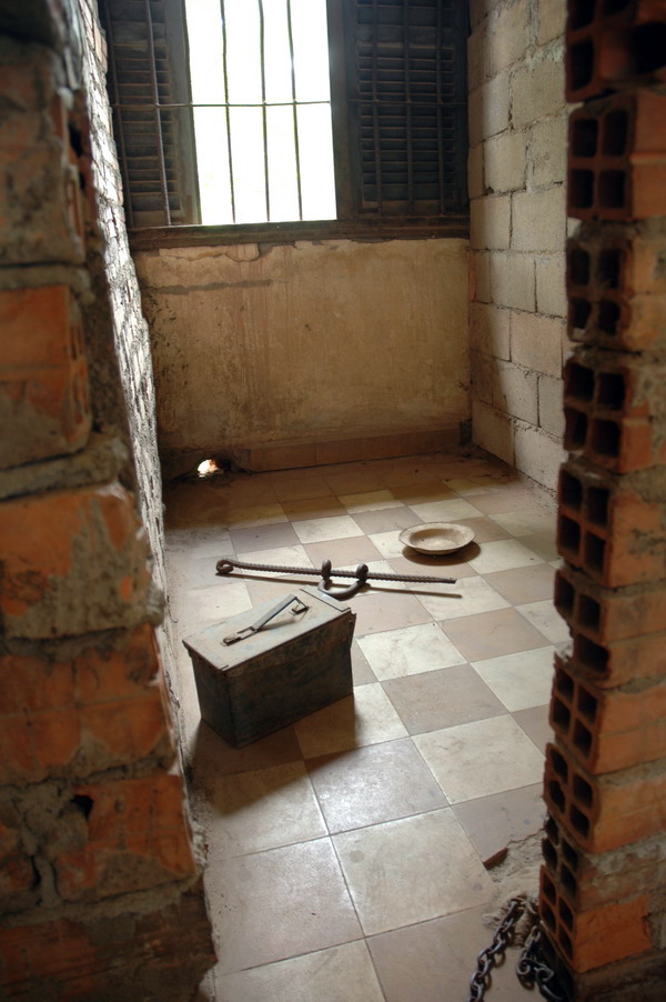 A jail cell and a toilet  and foot Iron