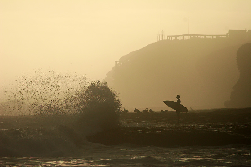 Silhouetted surfer