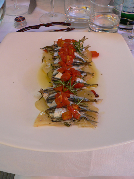 Tegame alla Vernazza is the most typical main course in Vernazza: anchovies, potatoes, tomatoes, white wine, oil, and herbs.