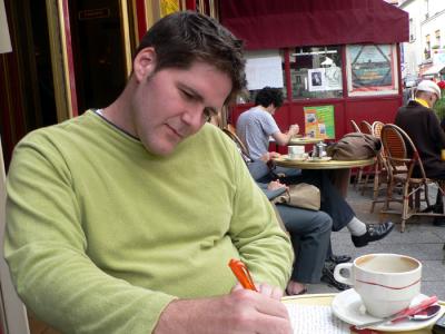 Writing our postcards in a Parisian cafe