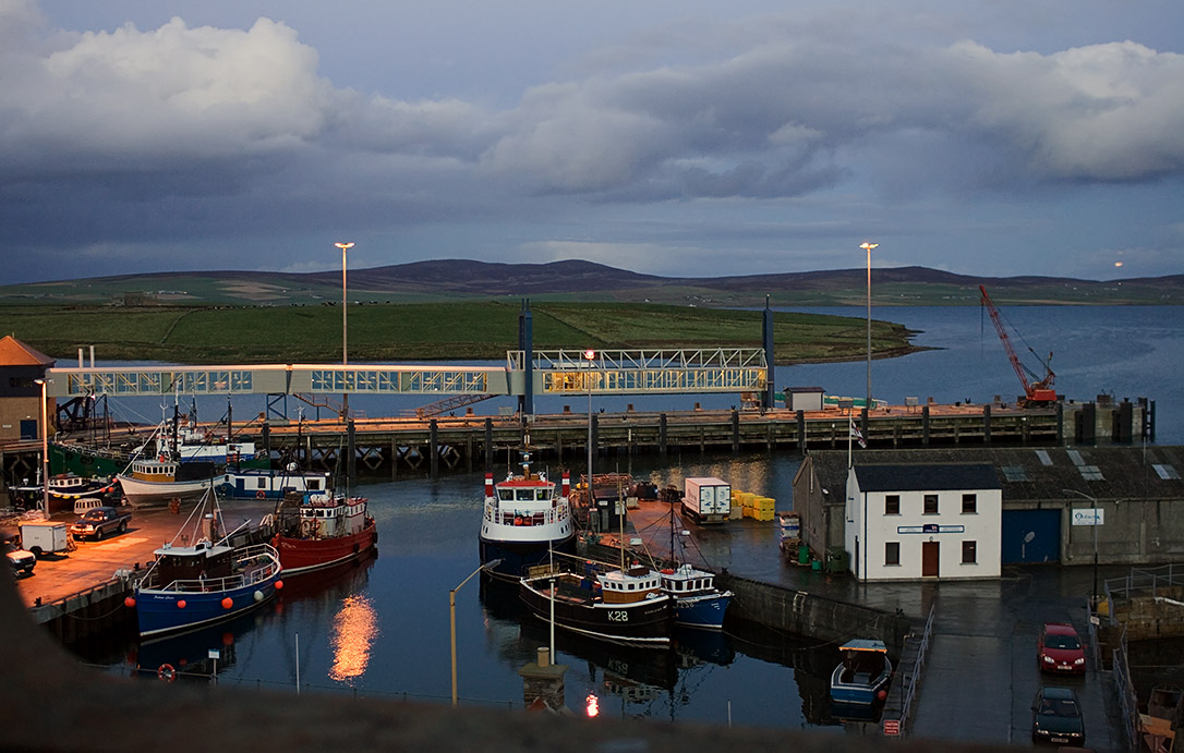 Night falls on the inner harbour with the mainland ferry still out.
