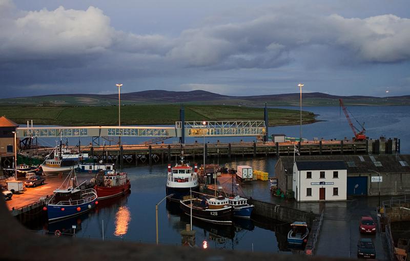 Night falls on the inner harbour with the mainland ferry still out.