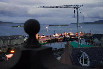Even with the crane looming, Shtromness Harbour and Scapa Flow look magical just after sunset.
