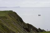 The magical island of Noss can be seen in the mist to the north of Sumburghs cliffs.