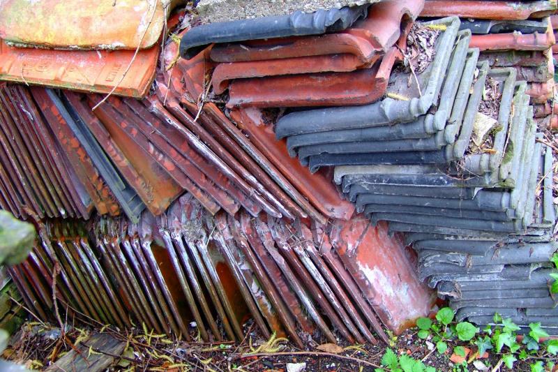 A chaotic pile of coloured roofing-tiles