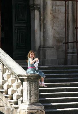 Young girl waits outside the church