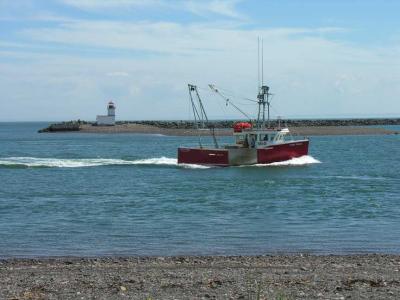 Parrsboro lighthouse with boat coming into the wharf