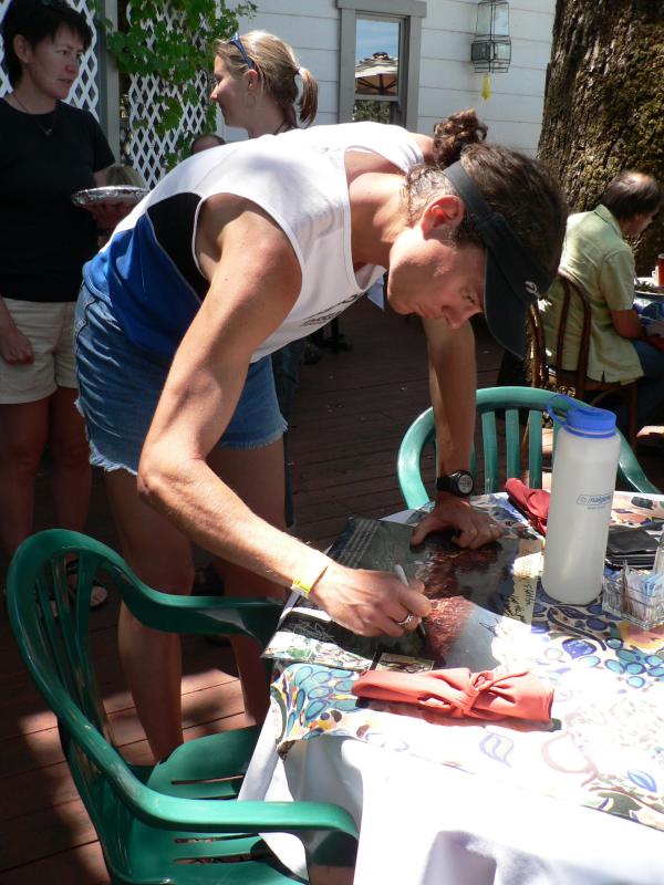 Scott signs a poster for the  Latitudes restaurant owner after brunch