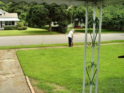 Leonard trimming the sidewalk
