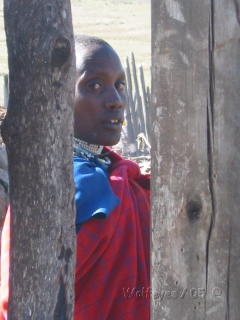 woman fixing hut. photo taken outside of village