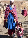 woman.child.carrying baby goats