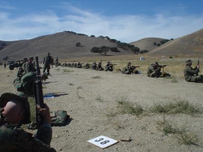 Looking down the firing line, shooters firing from the sitting