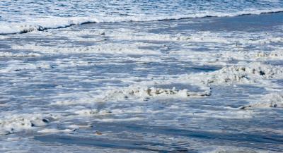 Waves created a foam resembling plastic