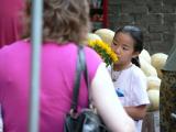 The sunflower is almost as big as the girl...