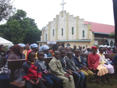 Sitting at the Family Day mass with the Kaburugi church in the background