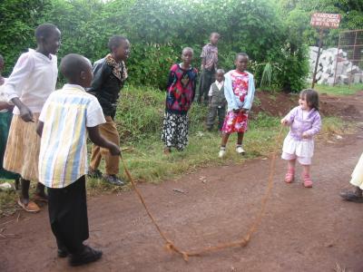 Tegan is invited by the kids to hold the skipping rope