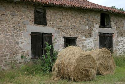 Hay bales and old barn