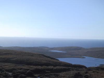 Loch Mheacleit with Flannan Isles on horizon.jpg