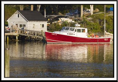 Lobsterboat reflected near bridge to Southport Island.