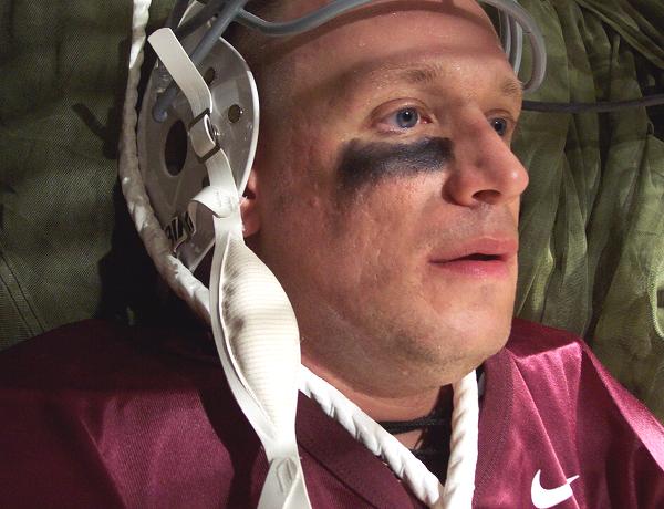 football player raised helmet resting
