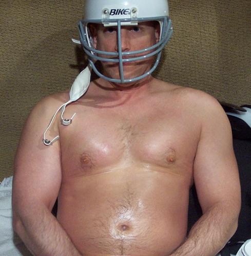 football player sitting resting bench sidelines