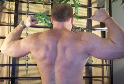 huge back muscles flexing large big lats