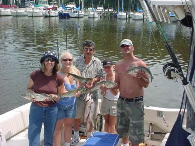 8/10/2005 Zai Family Charter show off some of a nice limit of Stripers and Bluefish caught onboad the Down Time