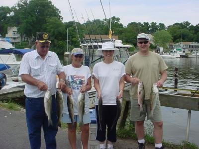 8/26/2005 - John Place Family Charter show off a nice limit of Stripers