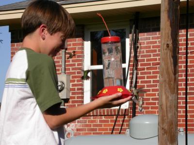 Cory feeding Ruby Throated Hummingbirds