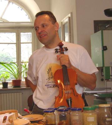 The violin maker and a finished instrument