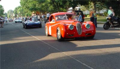 A FEW OLD JAGUARS, THE RED ONE IS THE OLDEST AND WAS THE FASTEST OF THESE THREE
