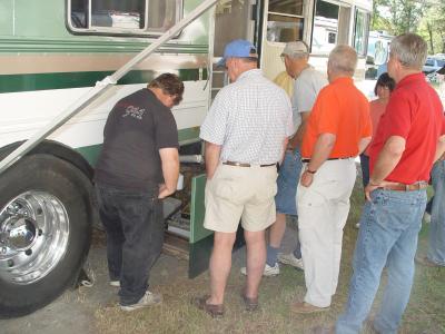 GEORGE GETS HELP ADJUSTING THE CHOKE SETTING ON HIS GAS GENERATOR