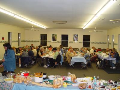 GOOD EATS AND CONVERSATION DURING THE POT LUCK AT THE CLUB HOUSE