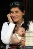 Woman, baby, phone in restaurant