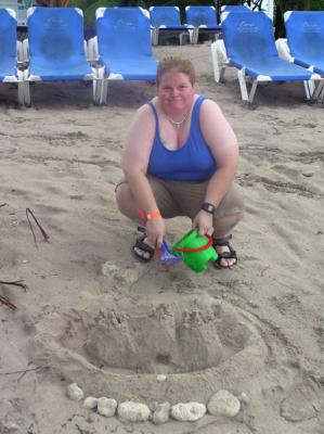 Julia making a sand castle on a rainy day