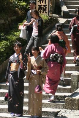Two young girls in kimono, also take a look at the skinny girl behind them
