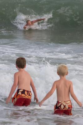 Brother Eric catching a good one, with his kids learning the finer points of body surfing