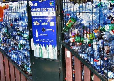 bottles for recycling in a barred cage.JPG