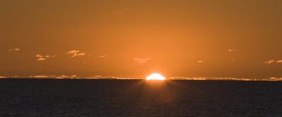 The sun is sinking into Lake Huron at Goderich, the west coast of Ontario