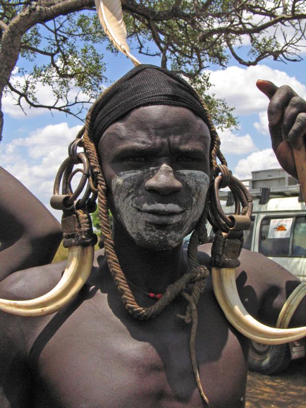 Mursi warrior meets tourist