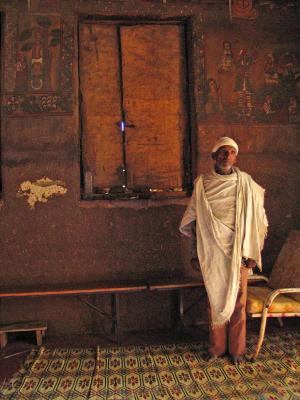 Priest in his church