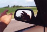 My hand in a car mirror