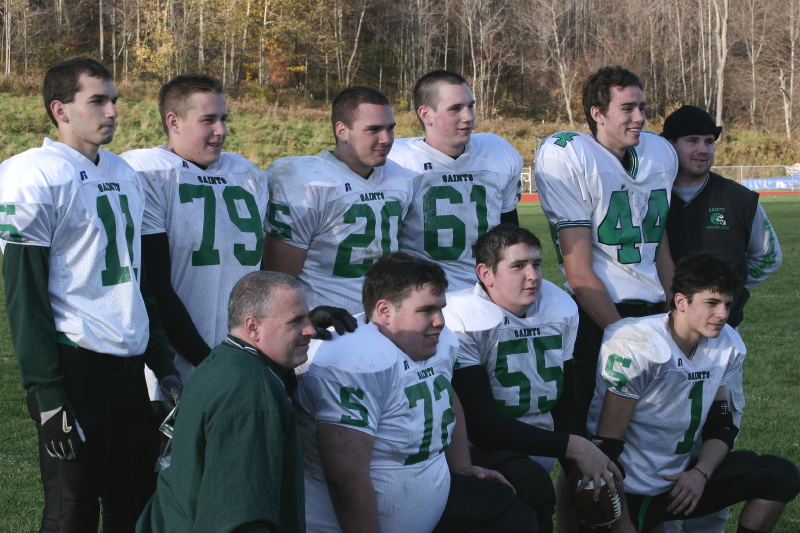 The eight seniors with coaches McManus and Rebello